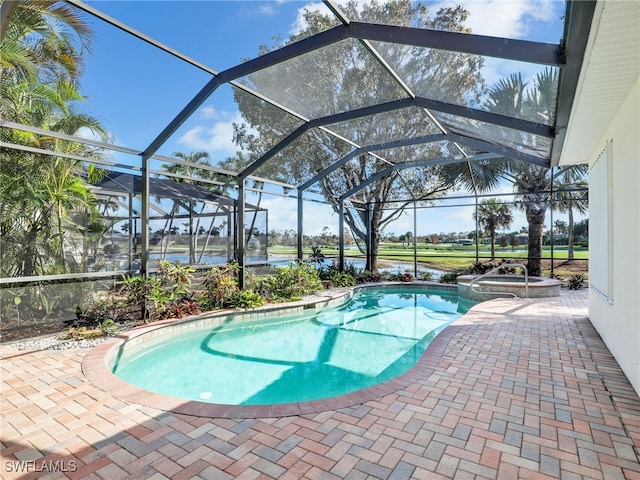 view of pool with a patio, a lanai, and an in ground hot tub