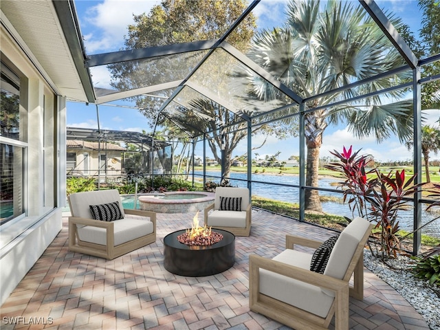 view of patio featuring a water view, an in ground hot tub, and glass enclosure