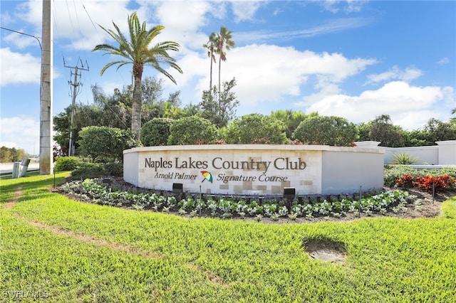 community / neighborhood sign featuring a yard