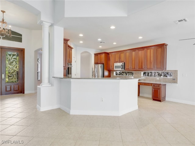 kitchen featuring kitchen peninsula, decorative backsplash, light tile patterned floors, ornate columns, and stainless steel appliances