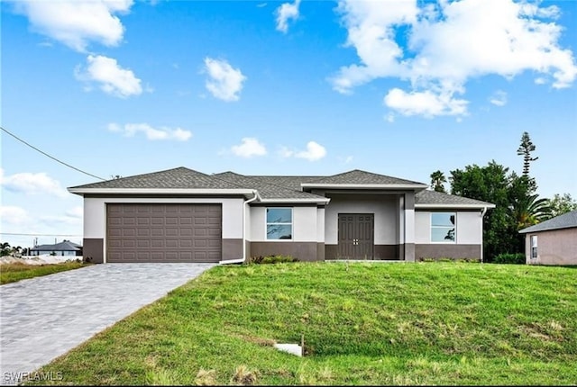 view of front of property featuring a garage and a front lawn