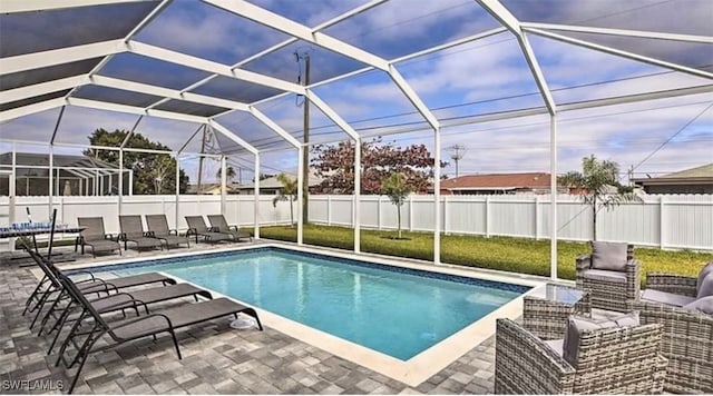 view of pool featuring glass enclosure and a patio area