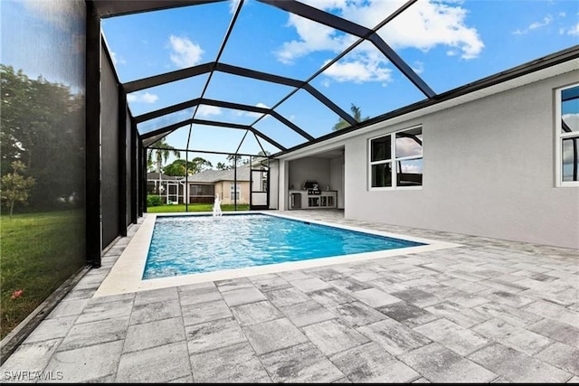 view of swimming pool featuring glass enclosure and a patio area