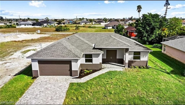 view of front of property featuring a garage and a front lawn