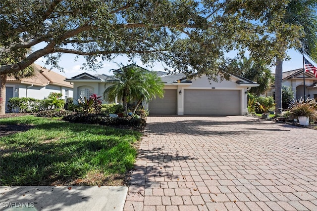 single story home with a front yard and a garage