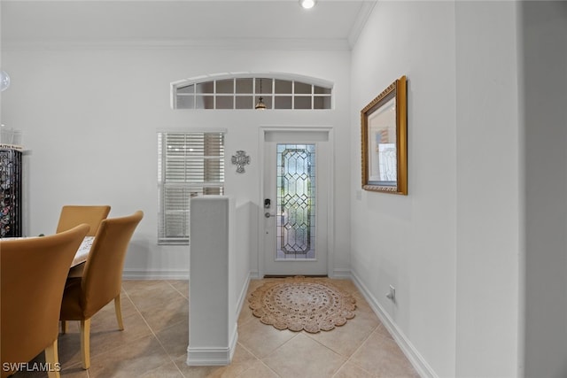 tiled entrance foyer featuring crown molding