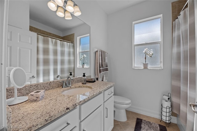 bathroom with vanity, toilet, and tile patterned floors