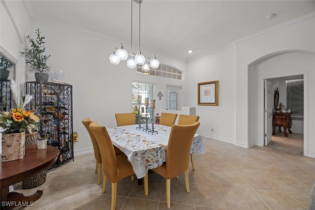 dining space featuring crown molding and light tile patterned floors