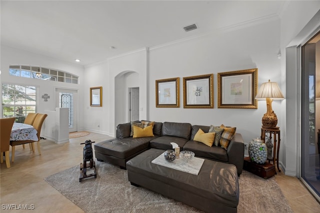 living room with ornamental molding and light tile patterned flooring