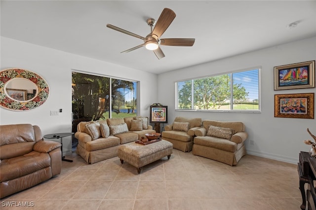 living room featuring light tile patterned floors and ceiling fan