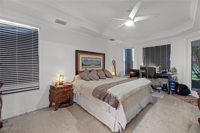 bedroom featuring ornamental molding, a raised ceiling, and ceiling fan