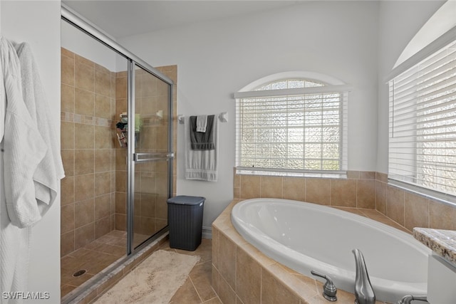 bathroom with independent shower and bath and tile patterned flooring