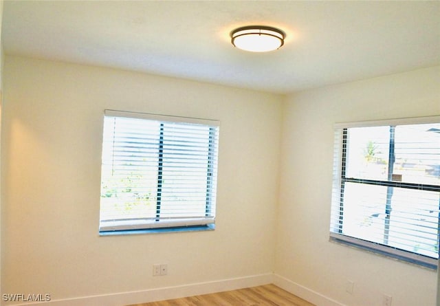 unfurnished room with plenty of natural light and light hardwood / wood-style flooring