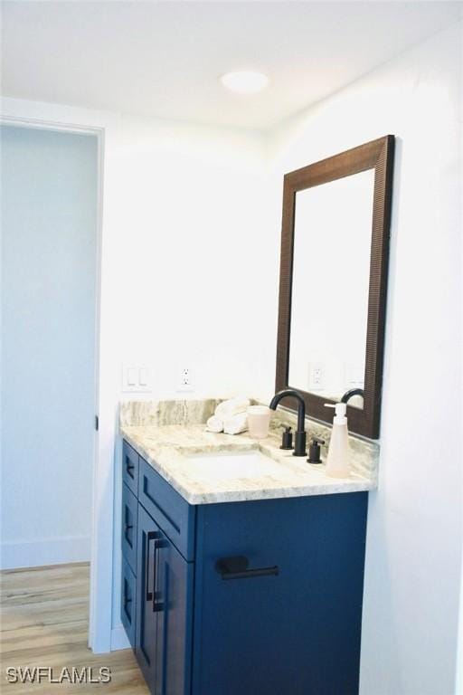 bathroom with hardwood / wood-style floors and vanity