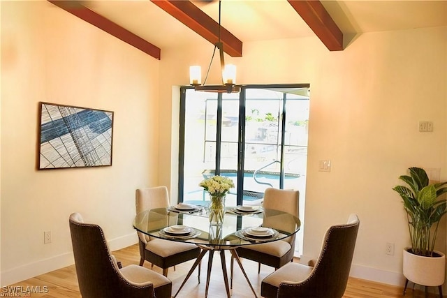 dining space with lofted ceiling with beams, light hardwood / wood-style flooring, and a notable chandelier