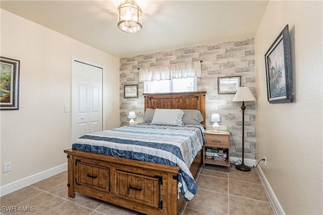 bedroom featuring a closet and light tile patterned flooring