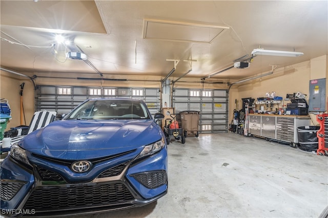 garage with electric panel and a garage door opener