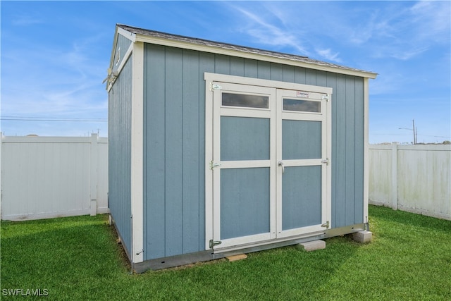 view of outbuilding with a lawn