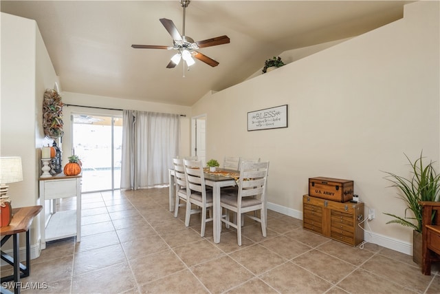 tiled dining space with ceiling fan and vaulted ceiling