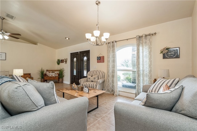 tiled living room with ceiling fan with notable chandelier