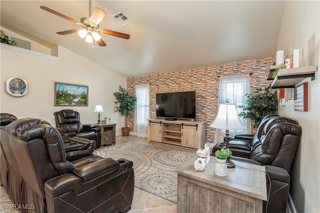 living room featuring lofted ceiling, light tile patterned floors, and ceiling fan