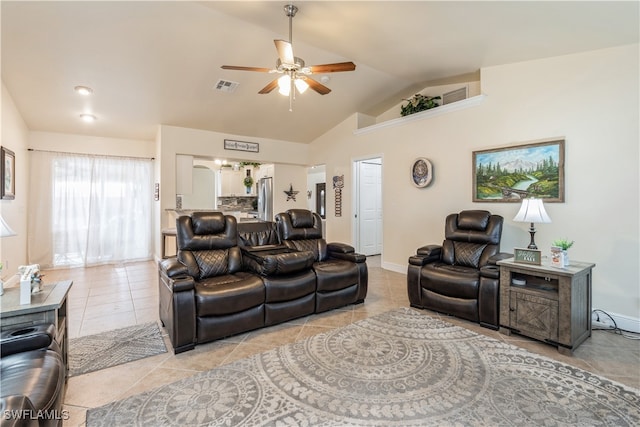 living room with lofted ceiling, light tile patterned floors, and ceiling fan