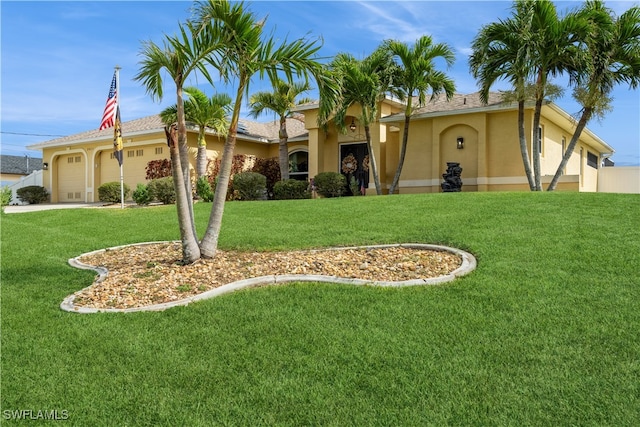 view of front of property with a garage and a front yard