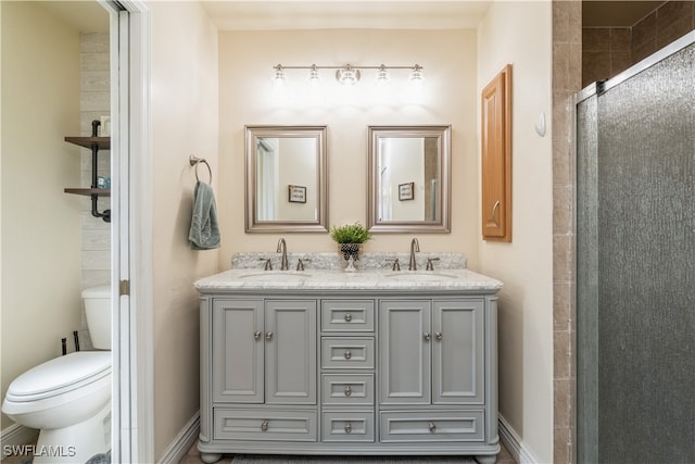 bathroom featuring vanity, toilet, and an enclosed shower