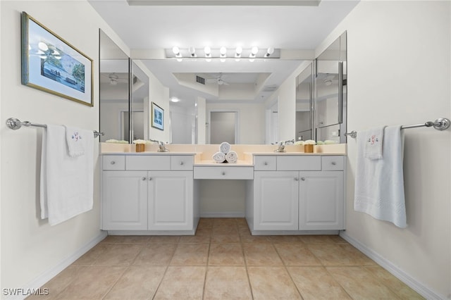 bathroom with a raised ceiling, tile patterned floors, vanity, and a shower with shower door