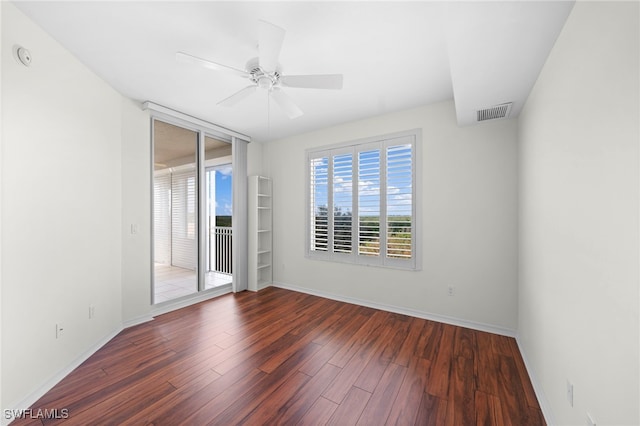 spare room with ceiling fan and dark hardwood / wood-style flooring