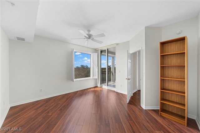 spare room featuring dark hardwood / wood-style flooring and ceiling fan