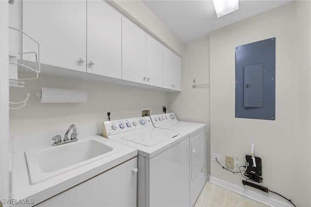 laundry area featuring cabinets, electric panel, washing machine and clothes dryer, and sink