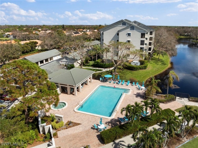 view of pool with a patio area and a water view