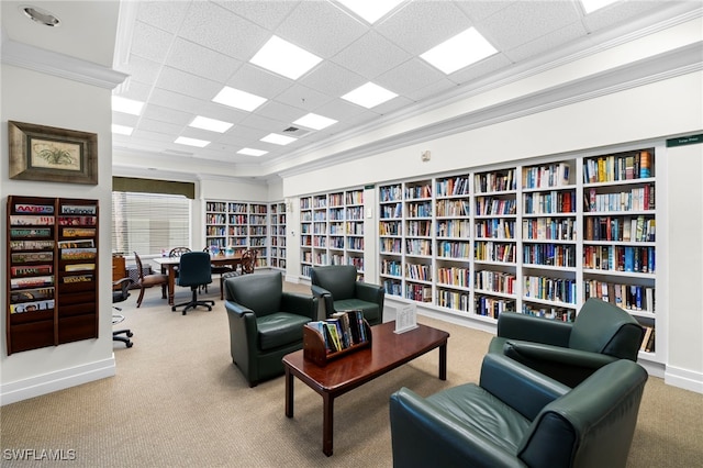 1001 Arbor Lake Dr Unit 307, Naples, FL 34110 - sitting room with bookshelves, carpet flooring, a paneled ceiling, and crown molding
