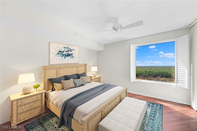 bedroom with dark hardwood / wood-style floors and ceiling fan