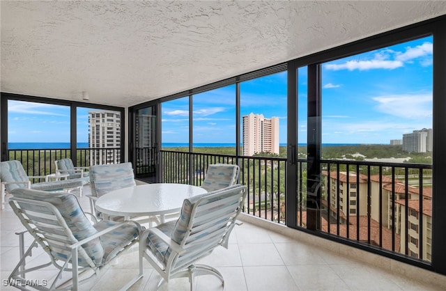 sunroom / solarium featuring a water view