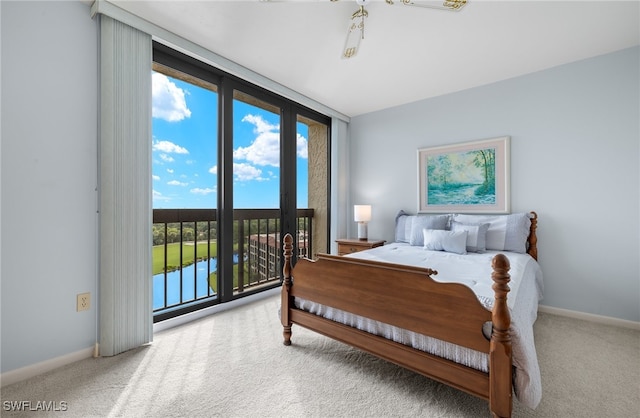 carpeted bedroom with a water view