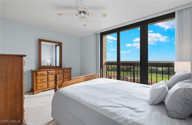 bedroom featuring carpet, a wall of windows, access to outside, and ceiling fan