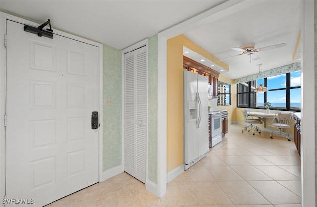 hall featuring light tile patterned floors