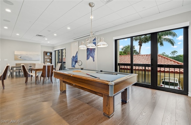 game room with hardwood / wood-style floors, crown molding, and pool table