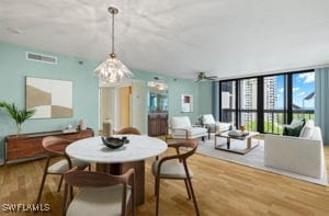 dining area featuring hardwood / wood-style flooring and ceiling fan