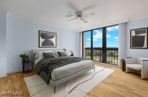 bedroom featuring access to exterior, light wood-type flooring, expansive windows, and ceiling fan