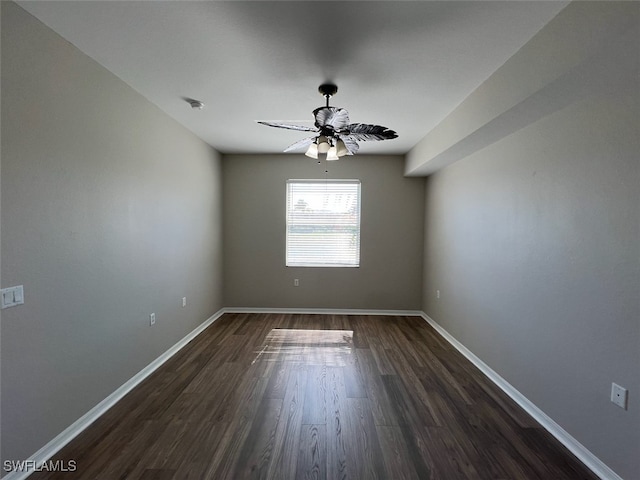 spare room with dark wood-type flooring and ceiling fan