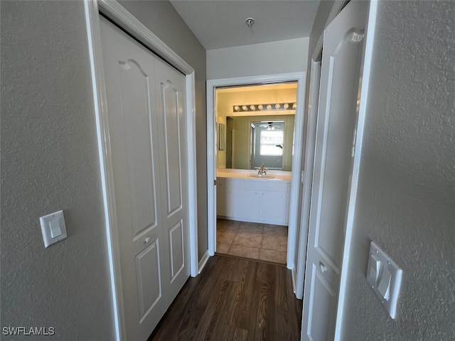 corridor with sink and dark hardwood / wood-style floors