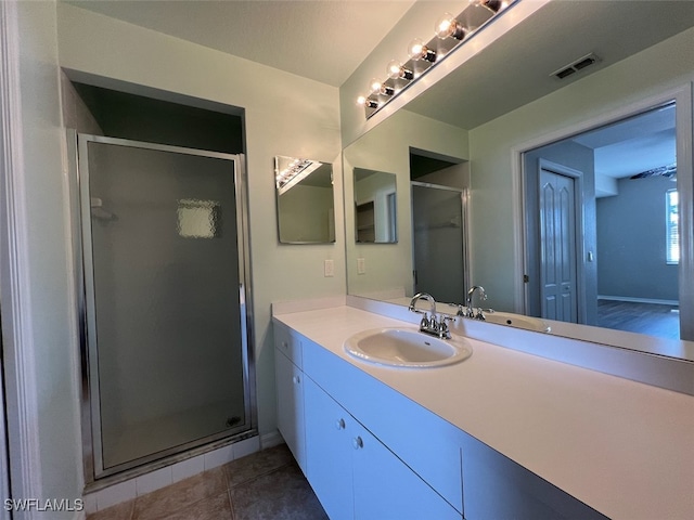 bathroom with vanity, tile patterned flooring, and walk in shower