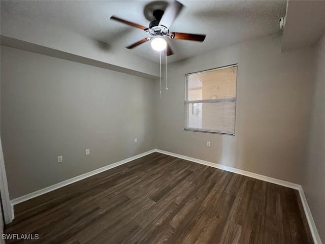 spare room with ceiling fan, a textured ceiling, and dark hardwood / wood-style floors