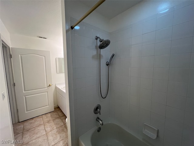 bathroom with vanity, tile patterned flooring, and tiled shower / bath