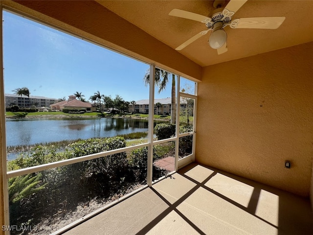 balcony with a water view and ceiling fan