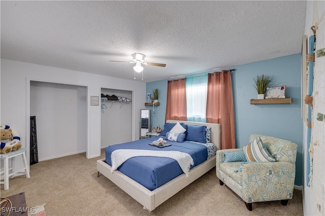 carpeted bedroom featuring ceiling fan and a textured ceiling