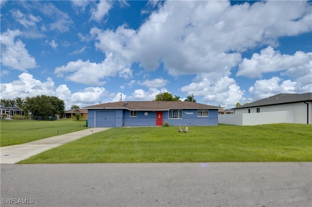 view of front of property featuring a garage and a front lawn